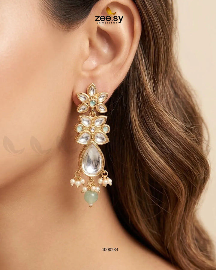 Floral drop stone necklace set with mint and green accents, featuring intricate design and matching earrings.