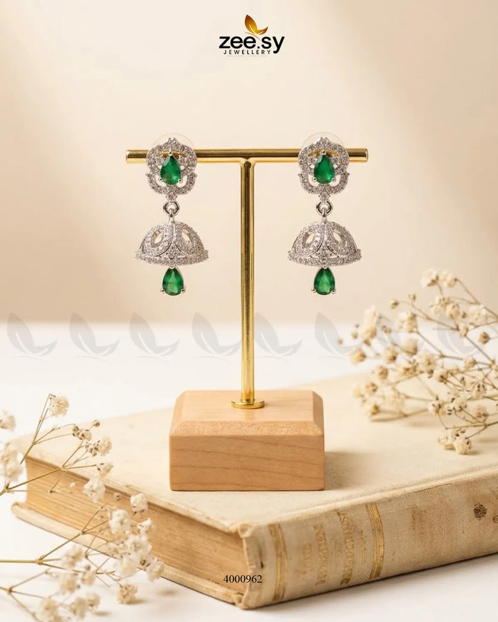 Ornate American diamond jhumka earrings with intricate design and gold finish, showcasing traditional Indian jewelry style.
