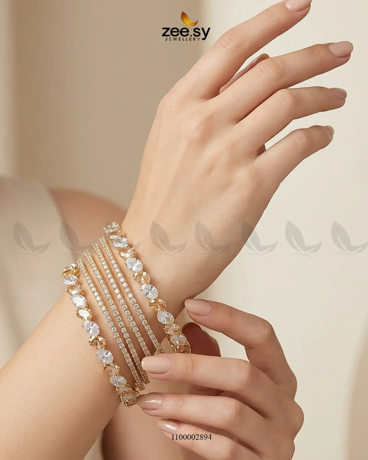 Oval gemstone paved bangles by AJ03 featuring sparkling gemstone accents and a sleek, elegant design in champagne color.