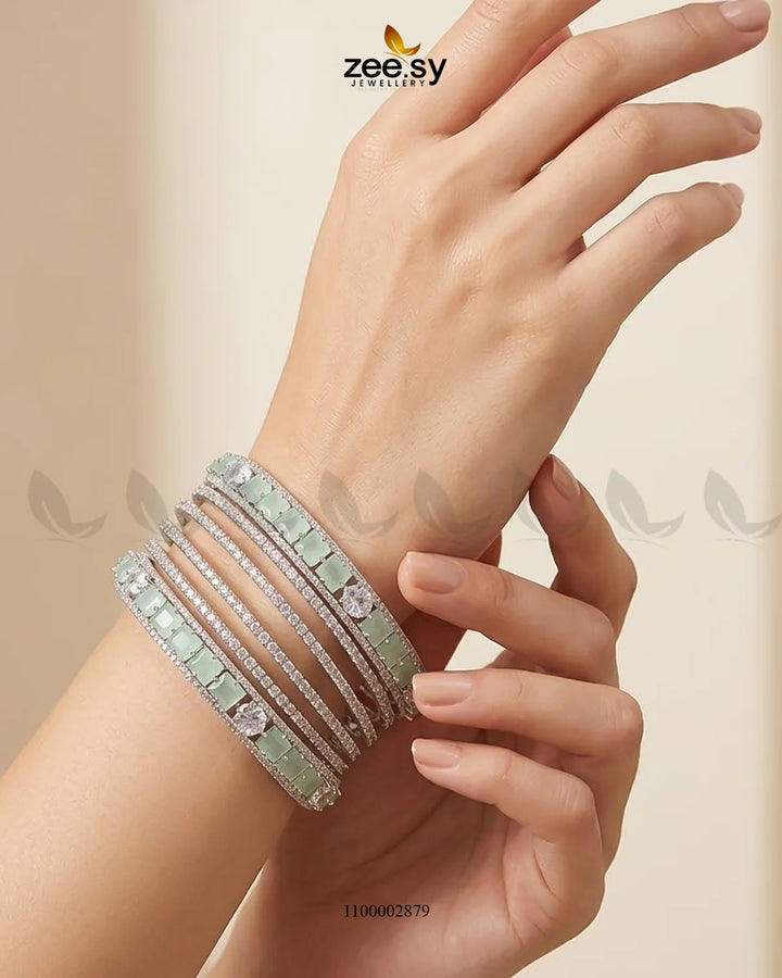 Silver princess cut zirconia bangle from AJ03, featuring sparkling princess cut stones on a sleek silver band.