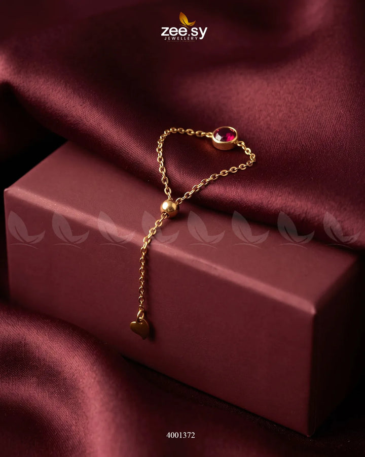 Red scarlet round stone finger ring from AJ03, close-up of the stylish jewelry piece with a polished band and vibrant gemstone.