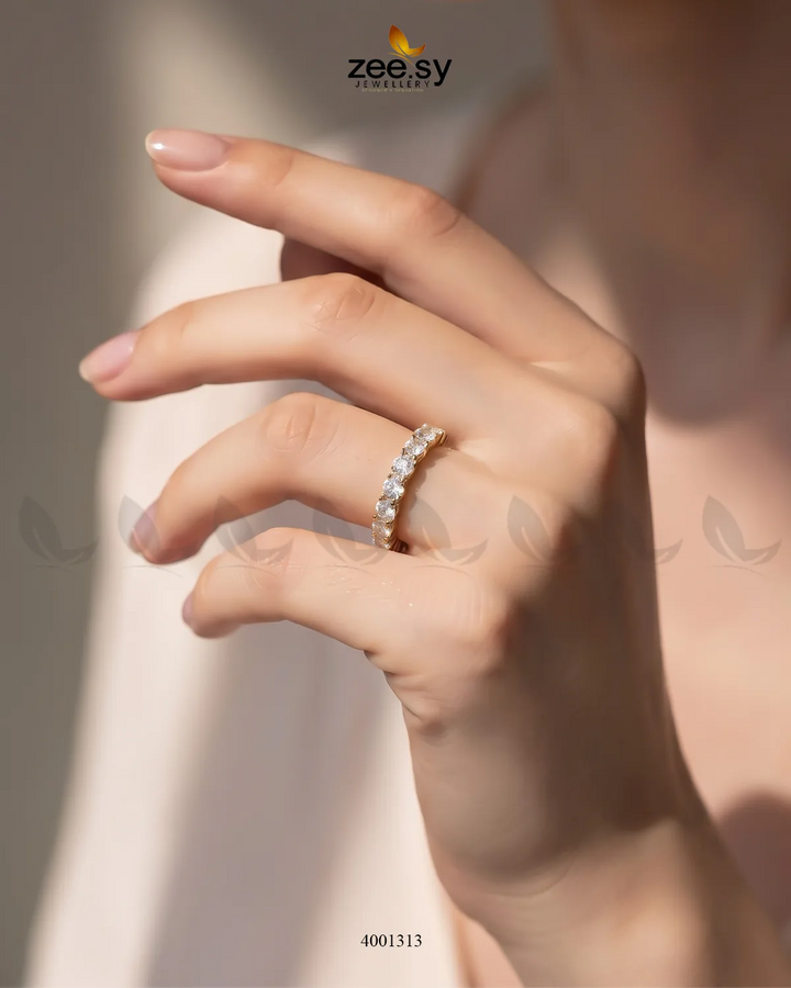 Shimmering crystal tennis ring by AJ03, featuring sparkling crystals set in a sleek silver band, showcasing elegant jewelry design.