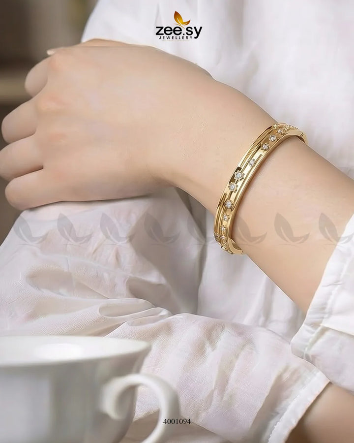 Sparkling zircon floral cuff bracelet with intricate design, silver-toned metal, and shimmering gemstone accents.