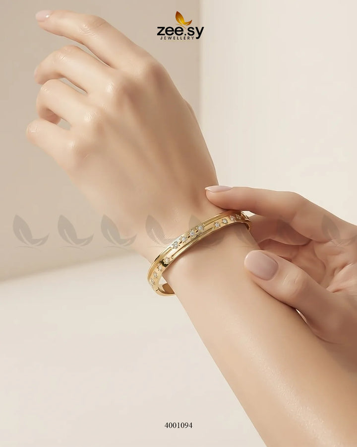 Sparkling zircon floral cuff bracelet by MH26 featuring intricate floral design and shimmering stones on a polished metal band.