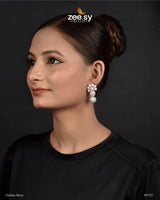 Akoya Earrings exquisite earrings feature a luxurious arrangement of pearls and diamond-cut stones, offering a perfect blend of elegance and sophistication. These Ethnic Festive Earrings top cluster design is adorned with shimmering stones, while the gracefully dangling pearls enhance the charm and femininity of the piece. Ideal for special occasions.