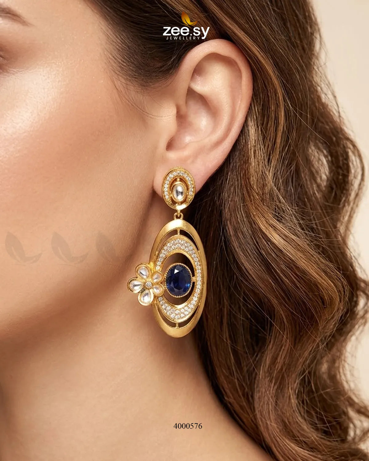 A pair of RHS09 Ameera gemstone drop earrings featuring vibrant blue gemstones and delicate metal hooks on a neutral background.