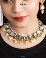 The Aqsa Necklace Set is an exquisite choker-style masterpiece that blends antique charm with traditional Kundan artistry. Showcasing high-quality Kundan stones set in an intricately crafted frame, this set exudes timeless elegance. The vintage-inspired detailing and delicate embellishments enhance its regal appeal, making it a perfect choice for weddings, festive occasions, and cultural celebrations.