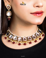 The Aqsa Necklace Set is an exquisite choker-style masterpiece that blends antique charm with traditional Kundan artistry. Showcasing high-quality Kundan stones set in an intricately crafted frame, this set exudes timeless elegance. The vintage-inspired detailing and delicate embellishments enhance its regal appeal, making it a perfect choice for weddings, festive occasions, and cultural celebrations.