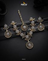 Aquilegia Necklace Set, a captivating floral-inspired design that blends modern elegance with traditional charm. Each intricately detailed flower motif is adorned with dazzling crystal glass stones, creating a striking contrast and luxurious appeal. Perfect for special occasions, this exquisite piece adds a radiant touch to any look.