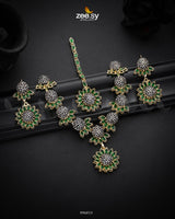 Aquilegia Necklace Set, a captivating floral-inspired design that blends modern elegance with traditional charm. Each intricately detailed flower motif is adorned with dazzling crystal glass stones, creating a striking contrast and luxurious appeal. Perfect for special occasions, this exquisite piece adds a radiant touch to any look.