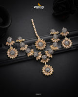 Aquilegia Necklace Set, a captivating floral-inspired design that blends modern elegance with traditional charm. Each intricately detailed flower motif is adorned with dazzling crystal glass stones, creating a striking contrast and luxurious appeal. Perfect for special occasions, this exquisite piece adds a radiant touch to any look.