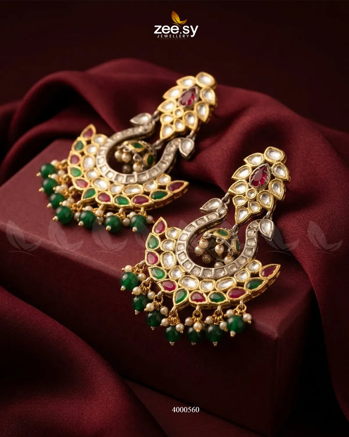 Gold-toned Aurelia Kundan Beads Earrings with intricate ruby and green gemstone accents, showcasing elegant traditional jewelry.
