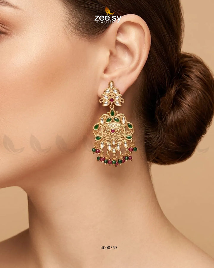 Red and green carved drop beads Kundan earrings with intricate detailing and traditional design, perfect for festive occasions.