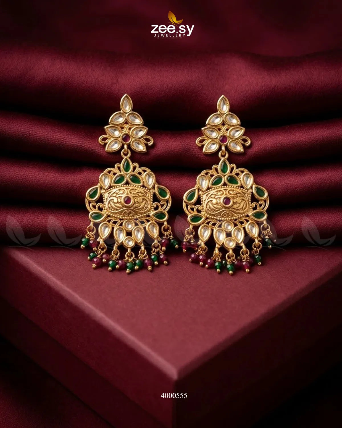 Red and green carved drop beads Kundan earrings with intricate detailing, traditional jewelry style for festive occasions.