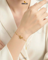 Delicate Fast Bundle ribbon bow charm bracelet with coordinating earrings, showcasing intricate design and soft colors.