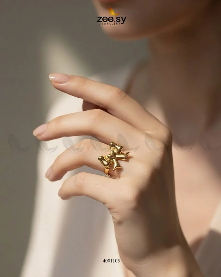 Elegant AJ03 Elegance Curved Bowknot Cocktail Ring featuring a sleek curved bowknot design in polished metal.