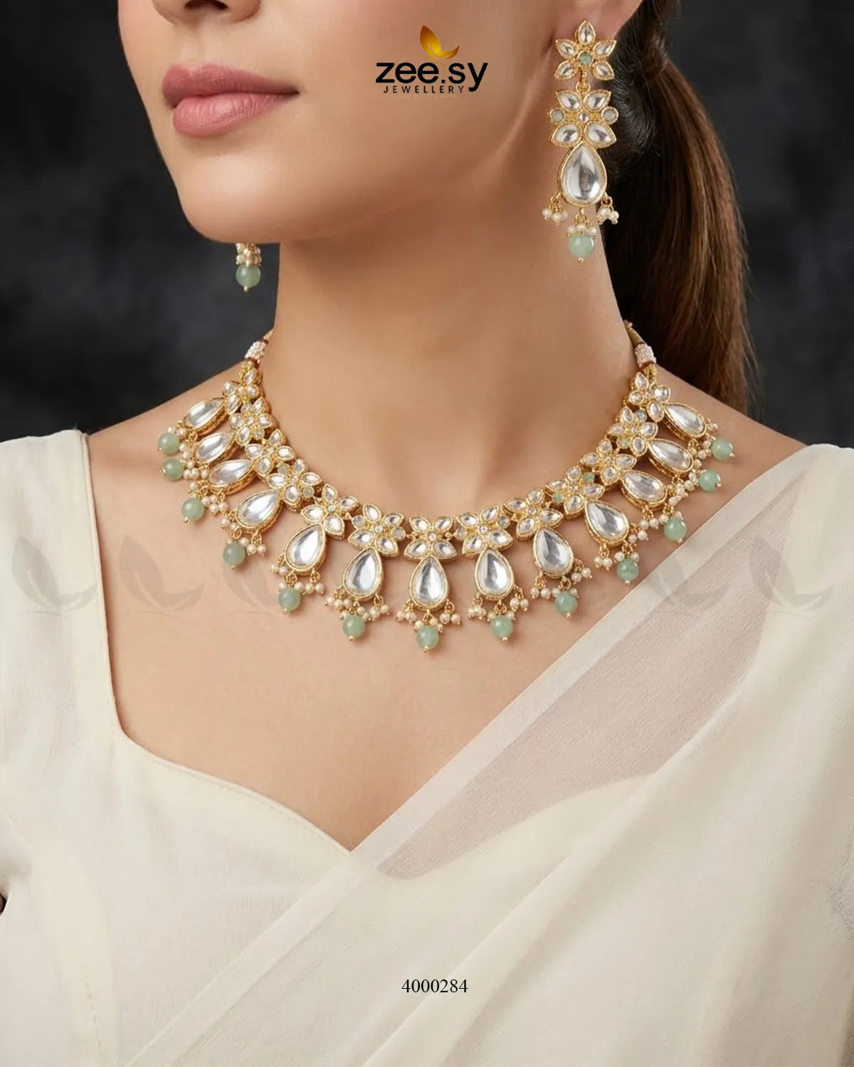 Elegant floral drop stone necklace set with mint and green tones, featuring intricate design and matching earrings.