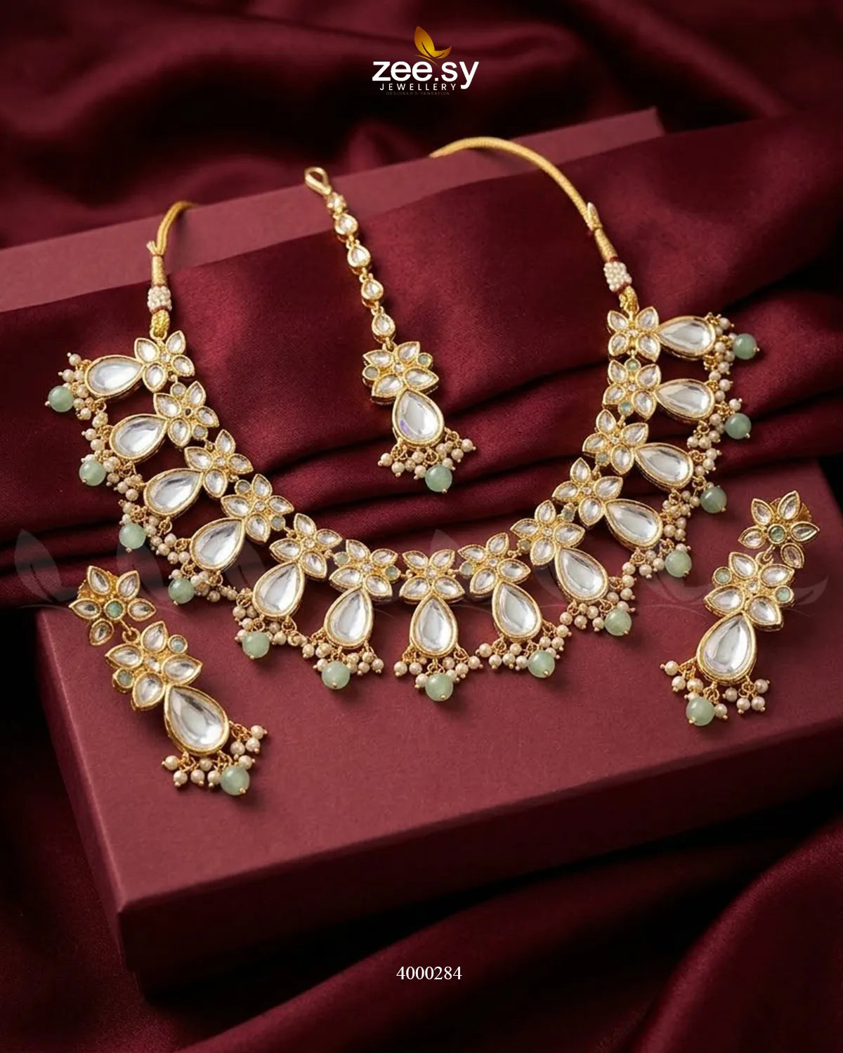 Elegant floral drop stone necklace set in mint and green hues, featuring intricate design and matching earrings.