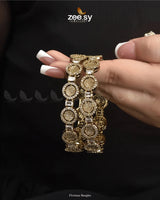 Floriana Bangles are a stunning collection, an elegant fusion of classic and contemporary design. Crafted with a golden polish, these exquisite kangans feature American-cut diamond stones that enhance their brilliance. This&nbsp;kada,&nbsp;regal accessory that blends durability with timeless artistry, ideal for weddings and festive occasions.