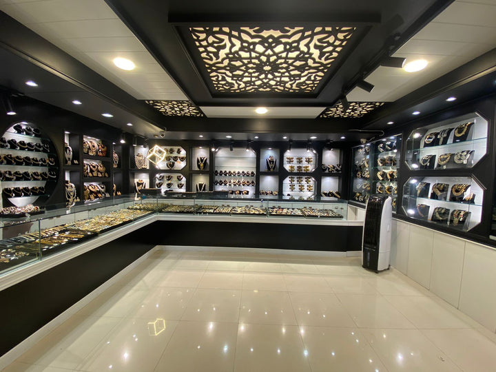 Luxury jewelry showroom interior with illuminated display cases, modern lighting, and premium jewelry collections
