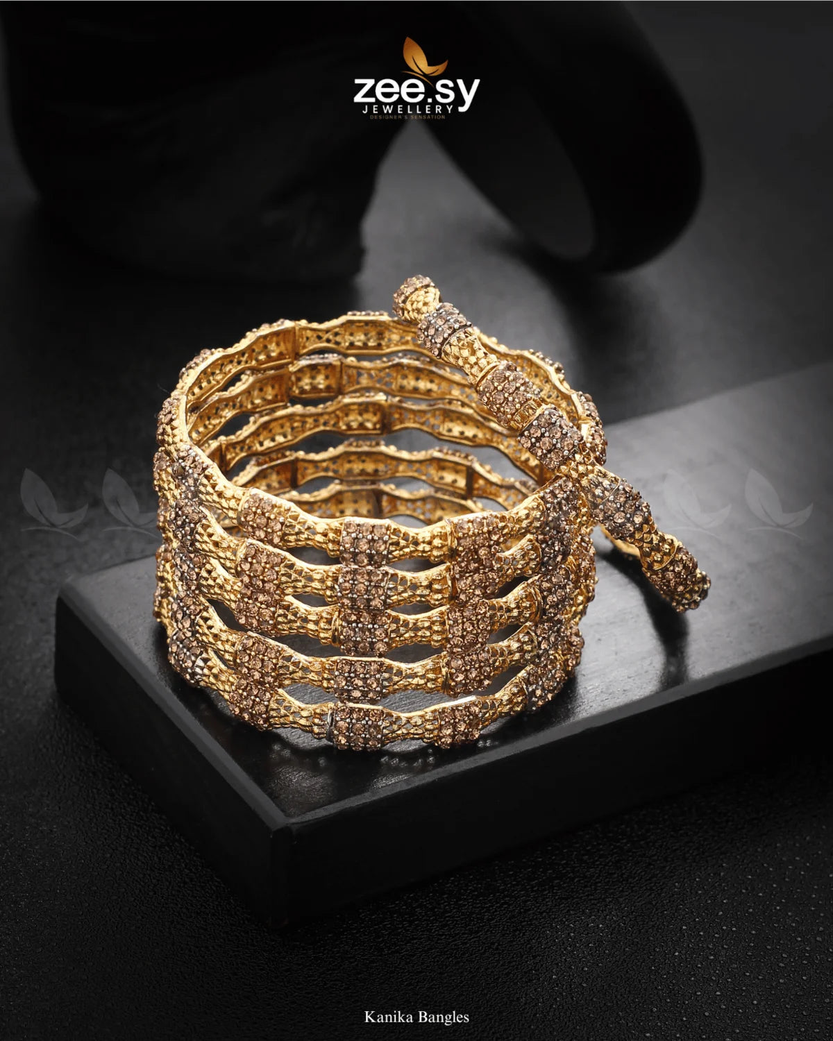 Kanika Bangles, feature an exquisite blend of intricate detailing and diamond-cut stone embellishments. The elegant textured design, enhanced with rhodium-polished accents, exudes sophistication and charm. Perfect for weddings, festive occasions, and celebrations, these bangles add a radiant touch to any traditional attire.