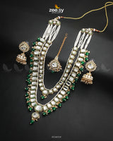 The Larkspur Malla Set is a masterpiece of royal elegance, this multi-layered necklace is adorned with finely cut Kundan stones and delicate beads. The intricate craftsmanship, combined with striking accents, creates a timeless look perfect for bridal and festive occasions. Elevate your ensemble with this majestic statement piece, exuding luxury and tradition.