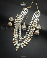 The Larkspur Malla Set is a masterpiece of royal elegance, this multi-layered necklace is adorned with finely cut Kundan stones and delicate beads. The intricate craftsmanship, combined with striking accents, creates a timeless look perfect for bridal and festive occasions. Elevate your ensemble with this majestic statement piece, exuding luxury and tradition.