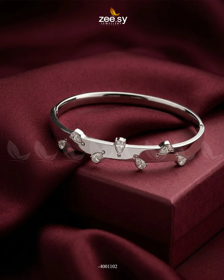 Silver minimalist droplet cuff bracelet by MH26, featuring a sleek, modern design with smooth, curved lines.