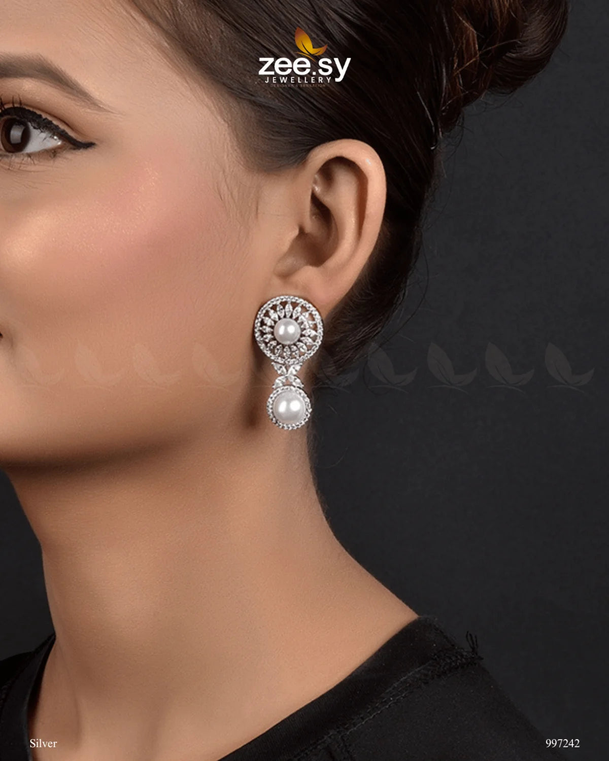 Mirella Earrings, These stud-drop earrings feature diamond-cut stones and crystal glass stones, beautifully arranged around a luminous central pearl. The intricate design showcases a delicate blend of traditional charm and modern sophistication, making them an ideal accessory for both festive and formal occasions.