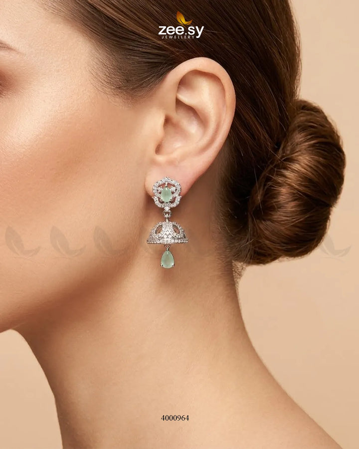 Ornate American diamond jhumka earrings with intricate gold-tone detailing and mint green accents, stylish traditional jewelry.