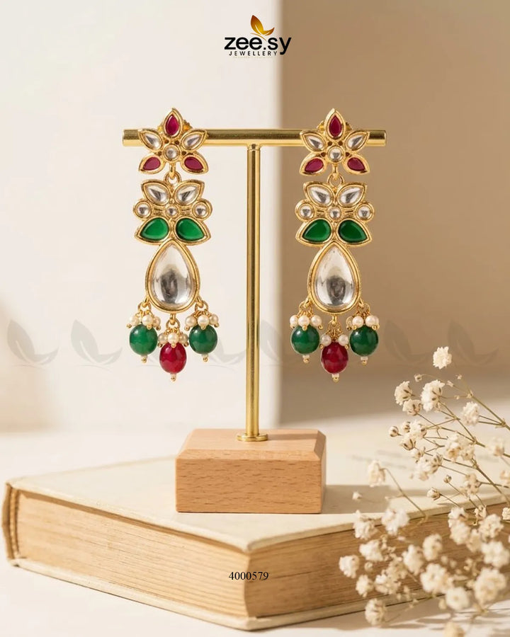 Ornate floral Polki statement earrings with intricate design in ruby and green hues, crafted by RHS09.