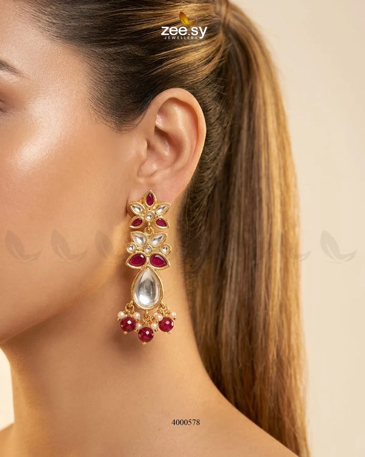 Ornate floral Polki statement earrings with intricate gold detailing and ruby accents, showcasing RHS09 brand craftsmanship.