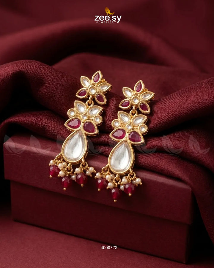 Ornate floral Polki statement earrings by RHS09 with intricate design and ruby accents, perfect for elegant traditional attire.