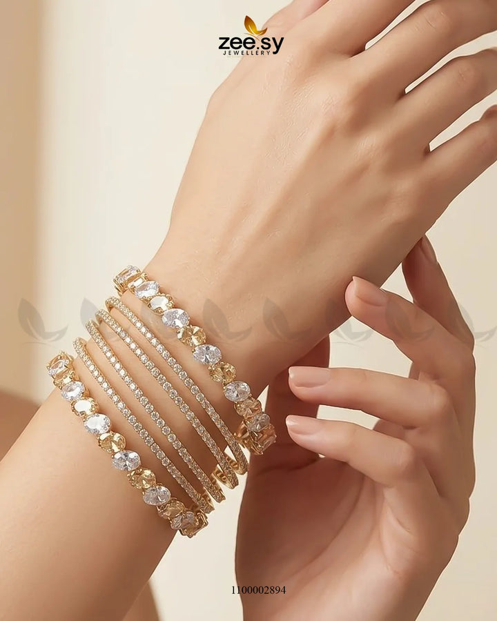 Oval gemstone paved bangles by AJ03 featuring sparkling gemstone accents on elegant gold-toned bangles.