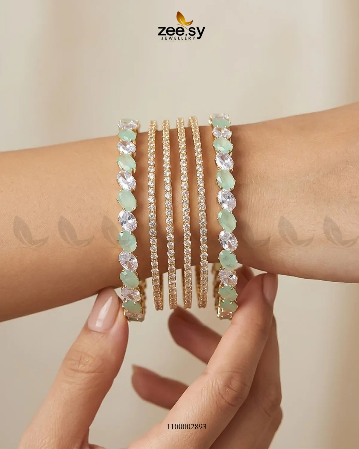 Mint green AJ03 oval gemstone paved bangles with intricate design, showcasing sparkling gemstones and elegant craftsmanship.