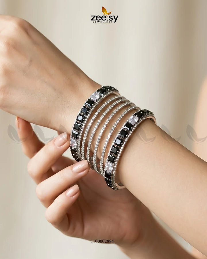 Silver princess cut zirconia bangle from AJ03, featuring sparkling cubic zirconia stones set in a sleek bangle design.