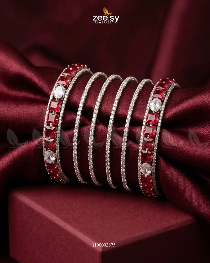 Silver princess cut zirconia bangle by AJ03 featuring sparkling princess-shaped zirconia stones on a sleek silver band.