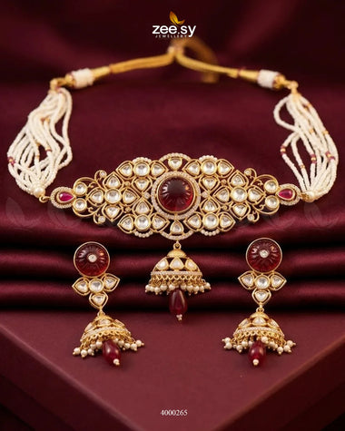 Elegant choker set featuring radiant pearl and jhumki design with ruby accents, perfect for traditional or festive occasions.