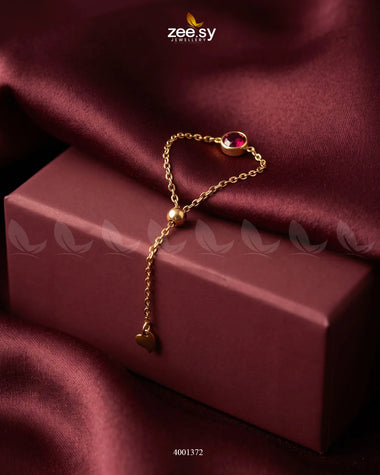 Red scarlet round stone finger ring from AJ03, close-up of the stylish jewelry piece with a polished band and vibrant gemstone.