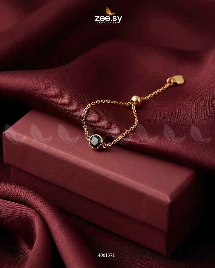 Black scarlet round stone finger ring by AJ03 featuring a sleek, polished design and a vibrant gemstone setting.