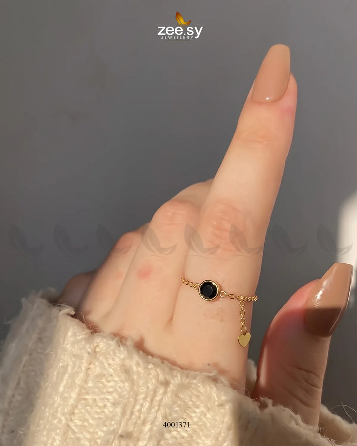 Black scarlet round stone finger ring by AJ03, showcasing a polished round gemstone set in a sleek metal band.