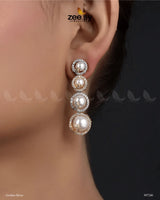 Simulated Earrings embody elegance and sophistication with their luxurious design. Featuring a dazzling arrangement of American-cut diamond stones, Vintage Pearl Earrings are adorned with luminous pearls in a cascading pattern, creating a graceful and timeless look. The refined setting is complemented by a golden or silver polish, adding a radiant finish that enhances their beauty.