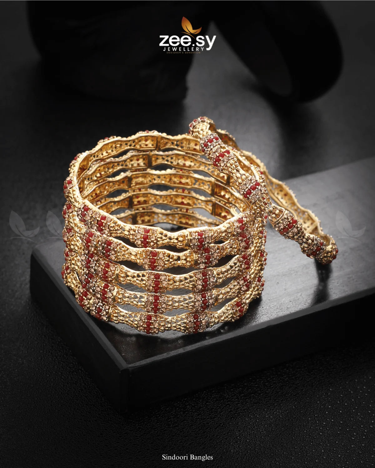 Sindoori Bangles feature an exquisite blend of intricate detailing and diamond-cut stone embellishments. The elegant textured design, enhanced with rhodium-polished accents, exudes sophistication and charm. Perfect for weddings, festive occasions, and celebrations, these bangles add a radiant touch to any traditional attire.