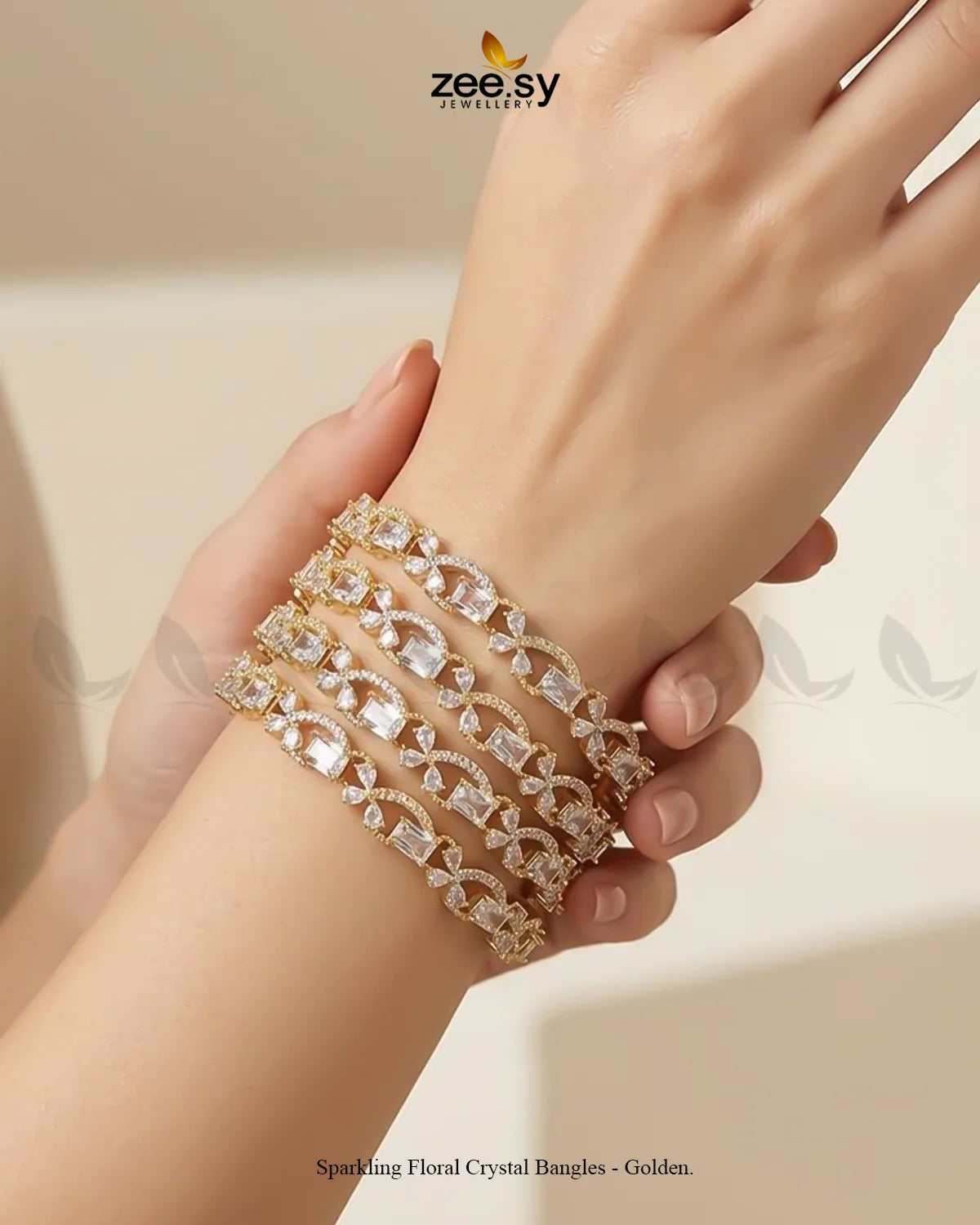 Golden sparkling floral crystal bangles from RHS09, featuring intricate designs and shimmering embellishments on a gold-toned bracelet.