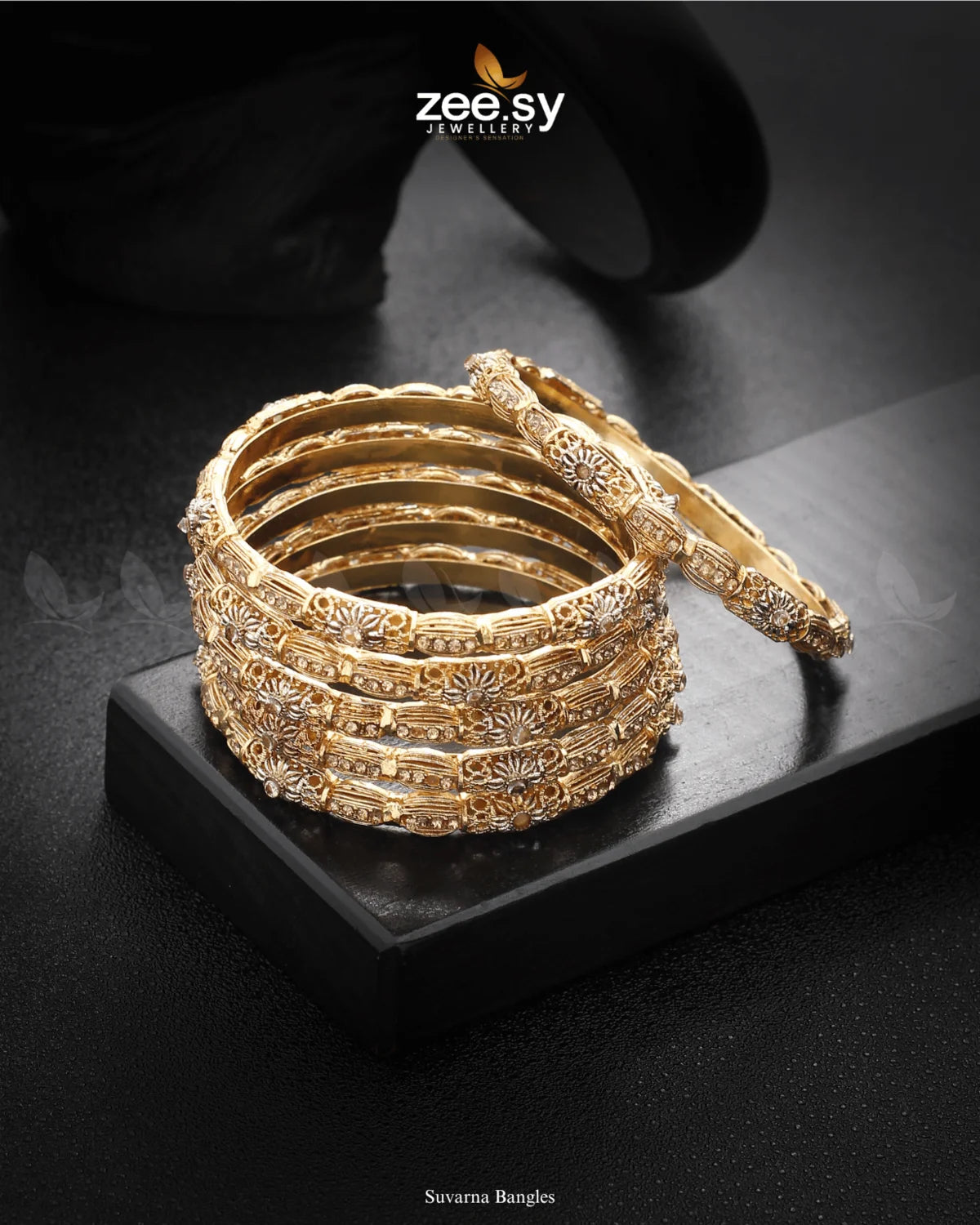 Suvarna Bangles feature intricate floral patterns with delicate stone embellishments, reflecting timeless elegance. The rhodium-polished accents add a radiant touch, enhancing their luxurious appeal. Perfect for festive occasions, weddings, and special celebrations, these bangles beautifully complement ethnic and bridal wear.