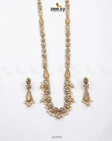 Gold necklace and earrings set with 'zeeszy' branding on a white background