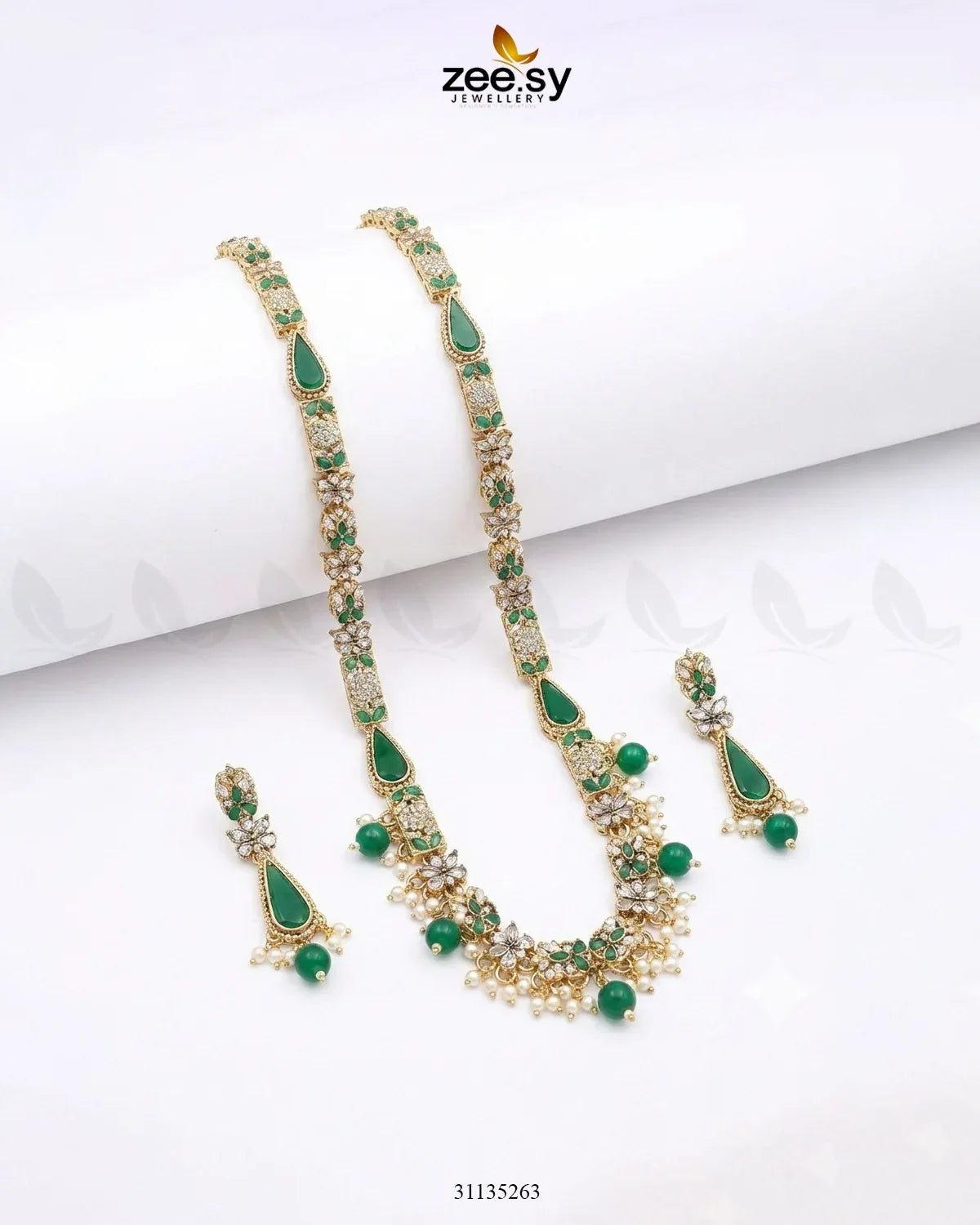Green gemstone necklace and earrings set on a white background with 'zeesy' branding.