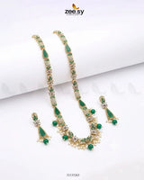 Green gemstone necklace and earrings set on a white background with 'zeesy' branding.