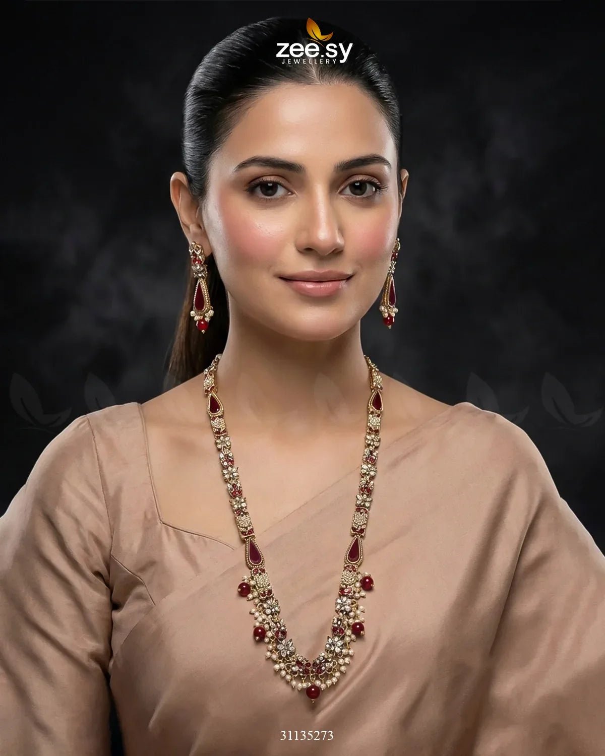 Woman wearing a long necklace with red stones on a dark background, featuring the Zee Sy logo.