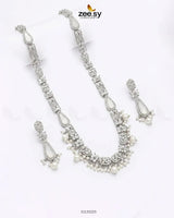 Silver necklace set with pearls and crystals on a white background, branded 'zeesy'.